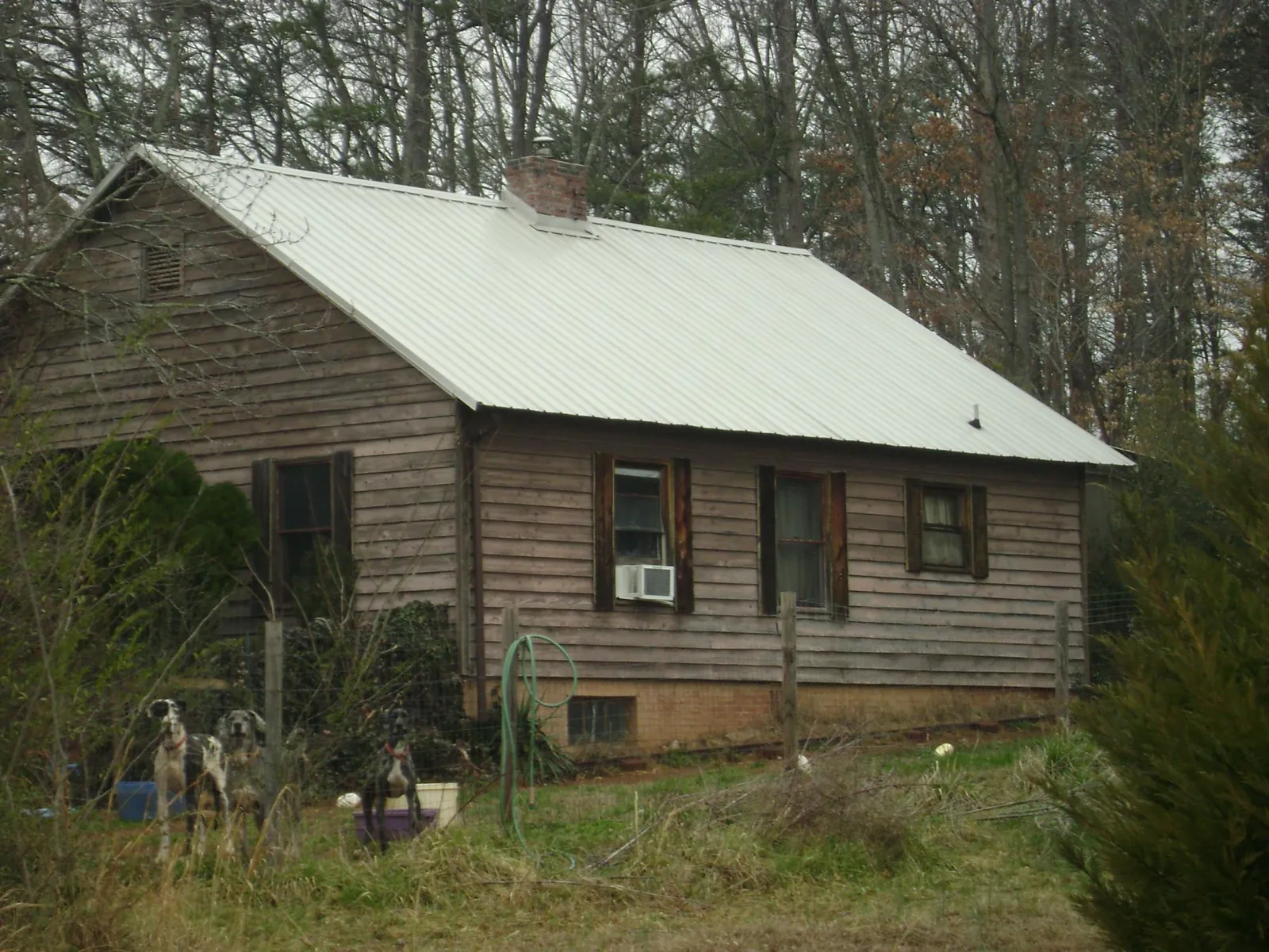 White metal roof on an old wood sided farmhouse, from a Asphalt Shingle Roof Repair job in Rosedale